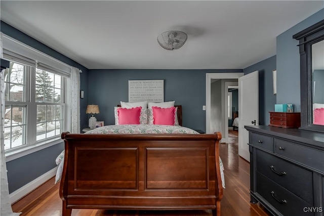 bedroom featuring dark wood-style floors and baseboards