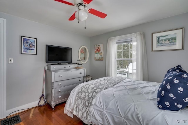 bedroom featuring baseboards, a ceiling fan, and wood finished floors