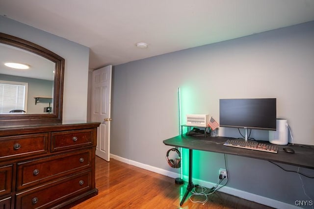 home office featuring light wood-type flooring and baseboards