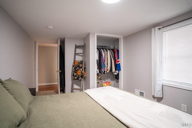 bedroom with a closet and visible vents