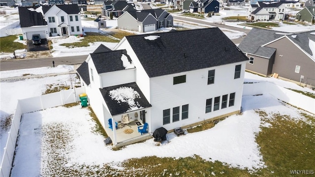 snowy aerial view featuring a residential view