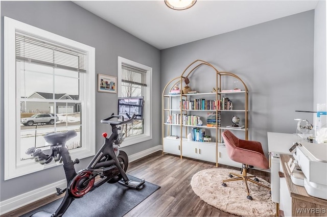 home office featuring baseboards and wood finished floors