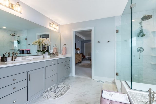 full bathroom featuring marble finish floor, visible vents, a sink, and a shower stall