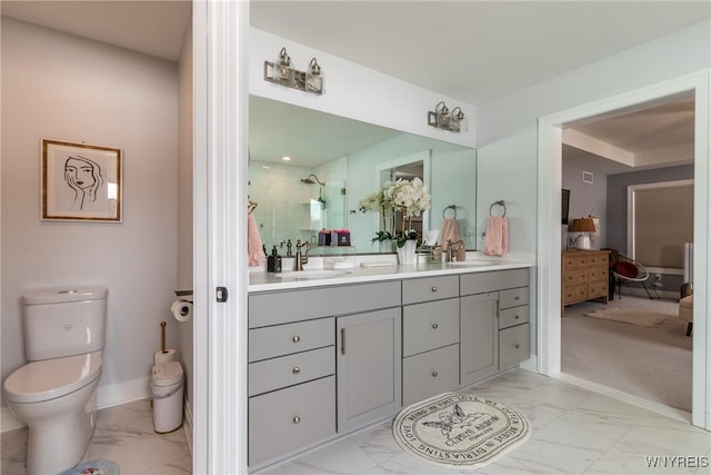 full bathroom with toilet, a sink, marble finish floor, tiled shower, and double vanity