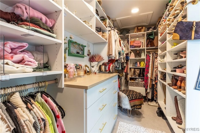 walk in closet featuring attic access