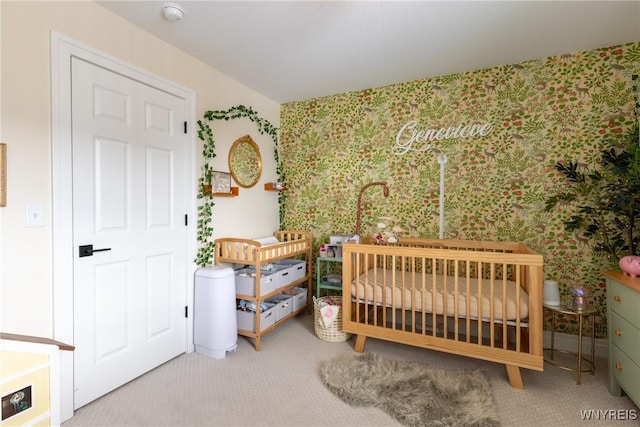 bedroom featuring a crib and carpet flooring