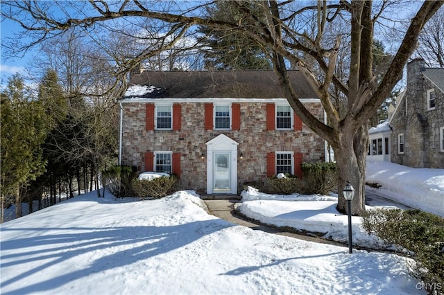 colonial home with stone siding