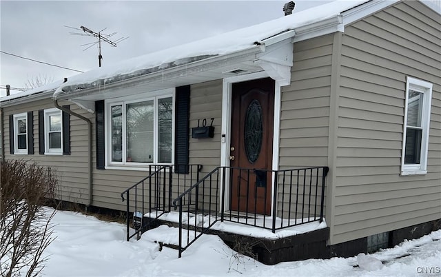 view of snow covered property entrance