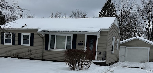 view of front facade with an outbuilding and a detached garage