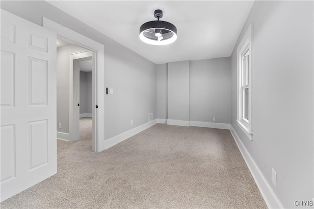 spare room featuring visible vents, baseboards, and carpet flooring