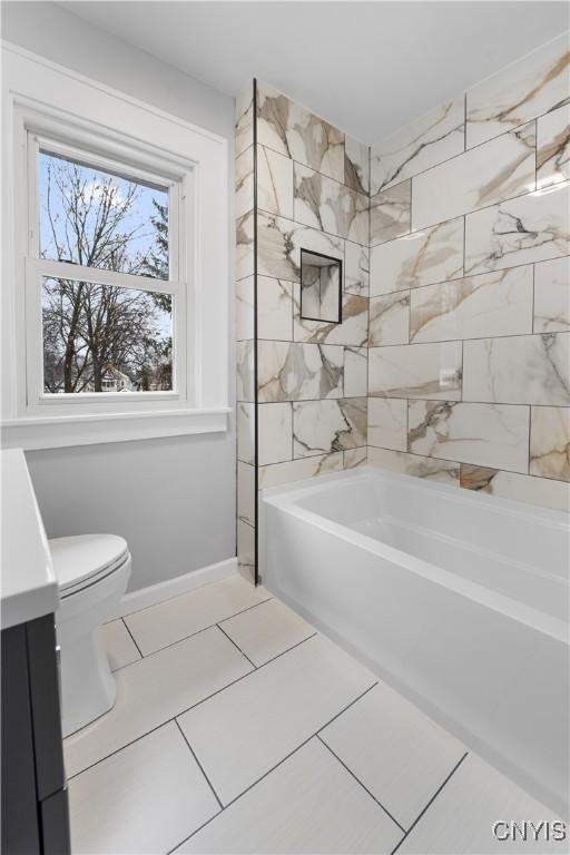 full bathroom with baseboards, shower / tub combination, and toilet