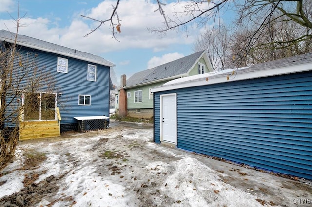 back of property with an outbuilding