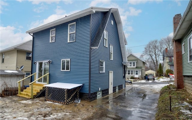 back of property featuring entry steps