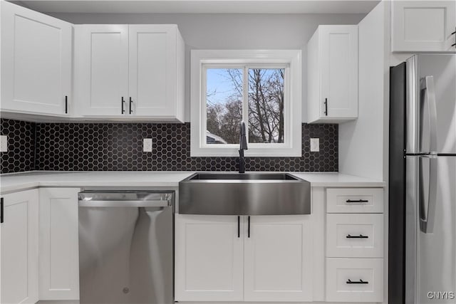 kitchen featuring white cabinets, stainless steel appliances, and a sink