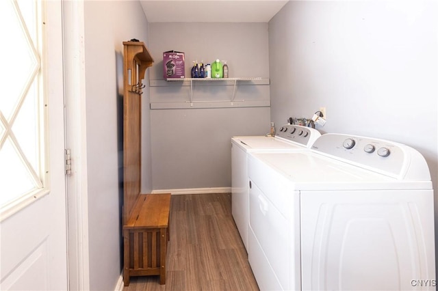 laundry area with laundry area, independent washer and dryer, and wood finished floors