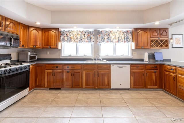 kitchen featuring brown cabinetry, dark countertops, white appliances, and light tile patterned flooring