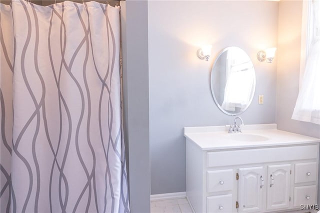 bathroom with vanity and baseboards