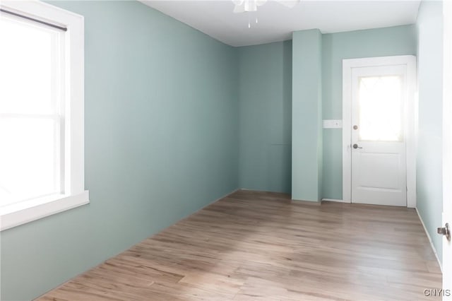 empty room featuring light wood-type flooring and ceiling fan