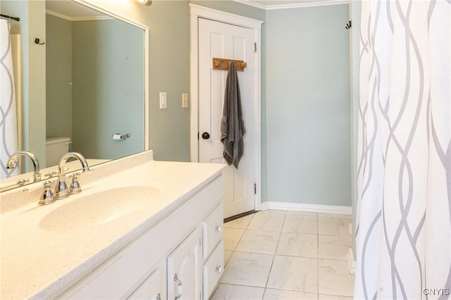 full bath featuring toilet, vanity, baseboards, marble finish floor, and crown molding