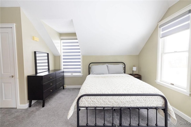 bedroom featuring carpet floors, baseboards, and lofted ceiling