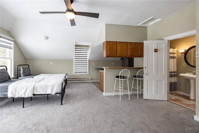 bedroom featuring attic access, light colored carpet, lofted ceiling, baseboard heating, and a sink