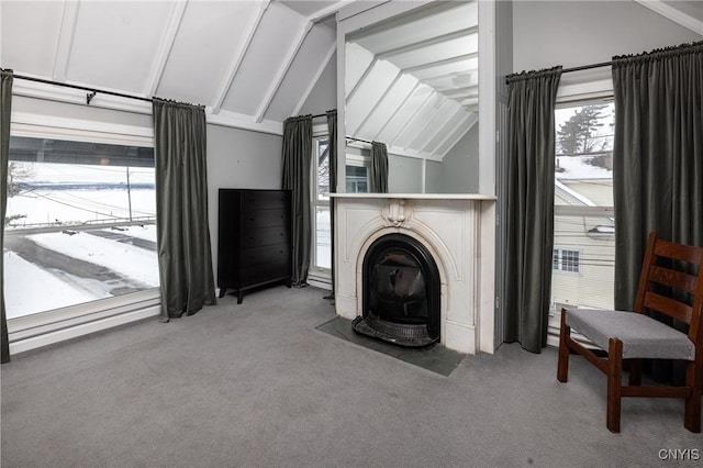 carpeted living area featuring lofted ceiling