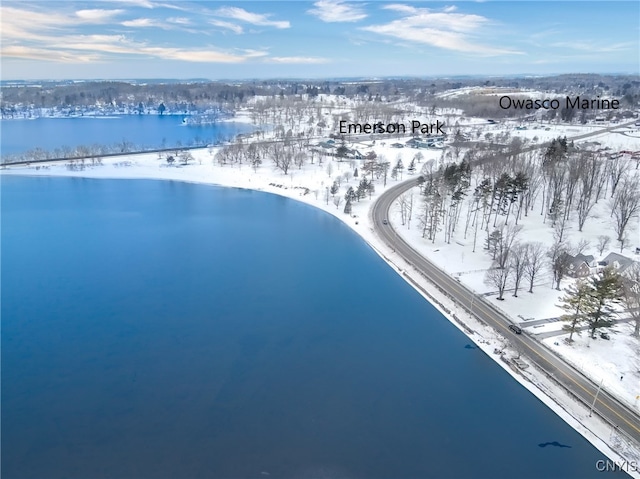 snowy aerial view featuring a water view