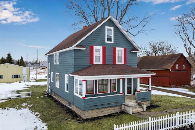 view of front of property featuring a shingled roof and fence private yard