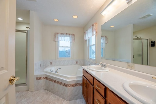 full bath featuring visible vents, a sink, a shower stall, and a bath