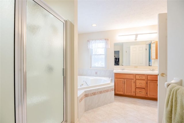 full bath with double vanity, a sink, a shower stall, a whirlpool tub, and tile patterned floors