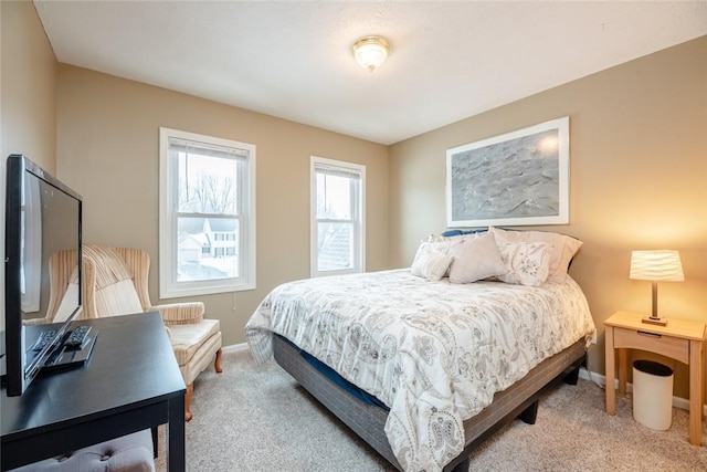 carpeted bedroom featuring baseboards