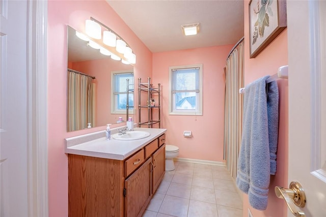 full bath with tile patterned flooring, baseboards, vanity, and toilet