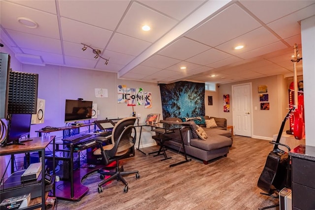 office area featuring a paneled ceiling, baseboards, wood finished floors, and recessed lighting