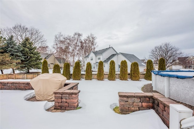 yard covered in snow with fence and a fenced in pool