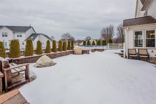 yard covered in snow featuring an outdoor pool and a patio