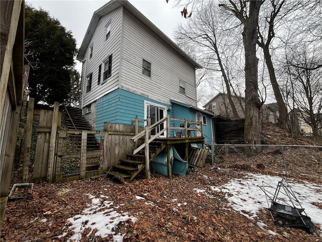 rear view of property featuring fence