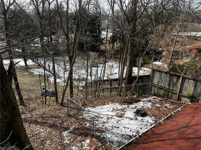 snowy yard with fence