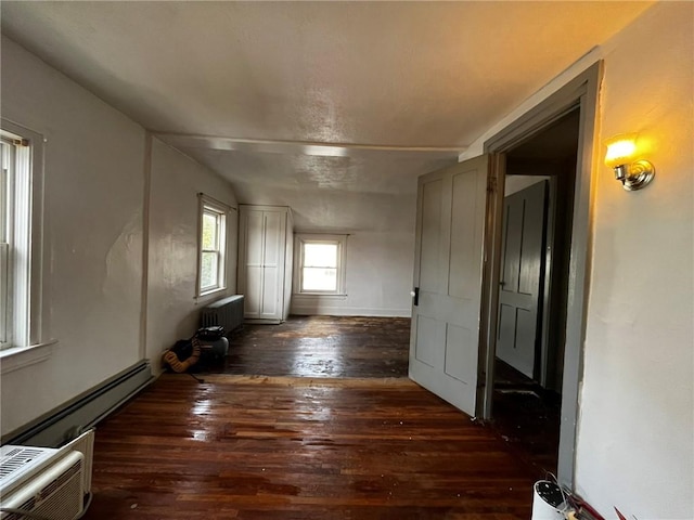 hallway featuring wood-type flooring, a baseboard radiator, and radiator