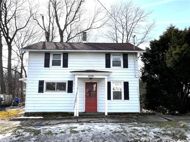 view of front facade with a chimney