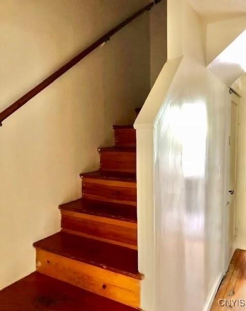 staircase with wood finished floors