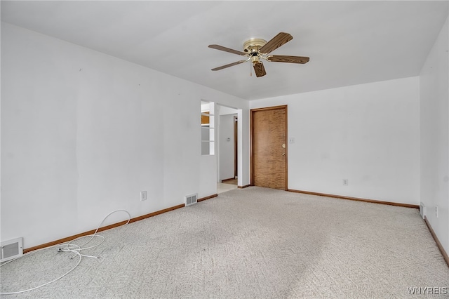 unfurnished room featuring a ceiling fan, baseboards, visible vents, and carpet flooring