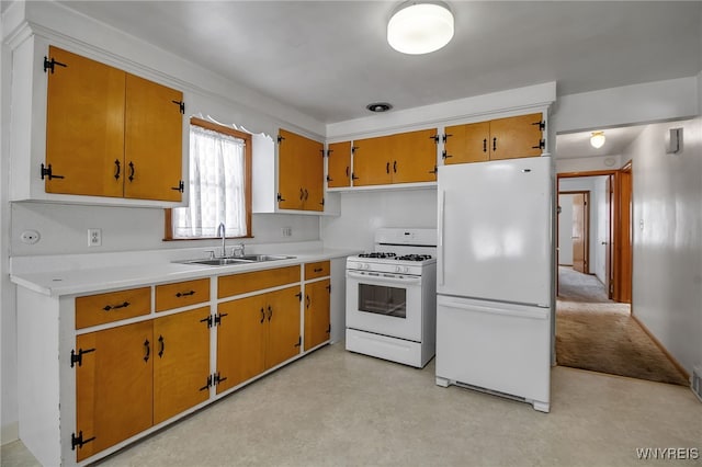 kitchen featuring white appliances, finished concrete floors, light countertops, and a sink