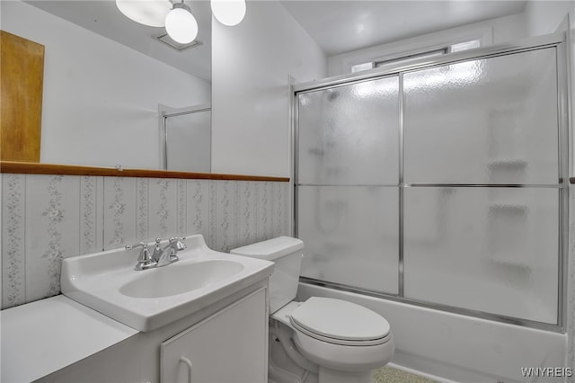 full bath featuring shower / bath combination with glass door, vanity, and toilet