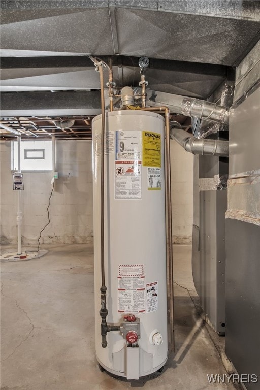 utility room with heating unit and water heater