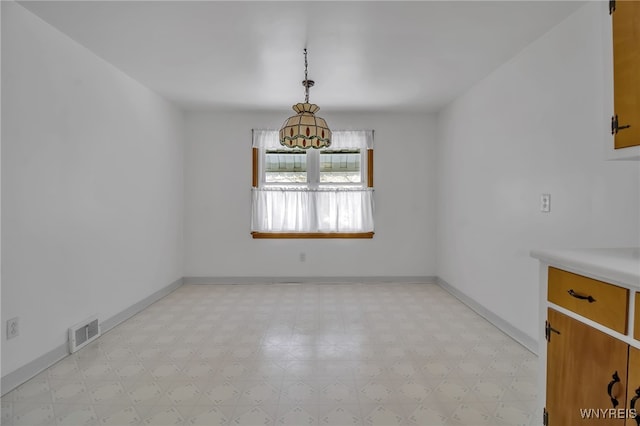 unfurnished dining area featuring light floors, baseboards, and visible vents