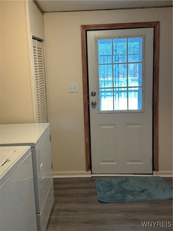 doorway to outside with baseboards, washer and clothes dryer, and dark wood finished floors