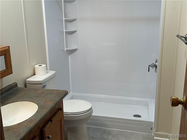 bathroom with a shower, vanity, and toilet