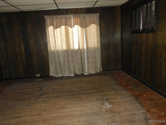 325 Ontario St, Lockport-City, NY 14094 - unfurnished room with wooden walls, hardwood / wood-style floors, and a paneled ceiling