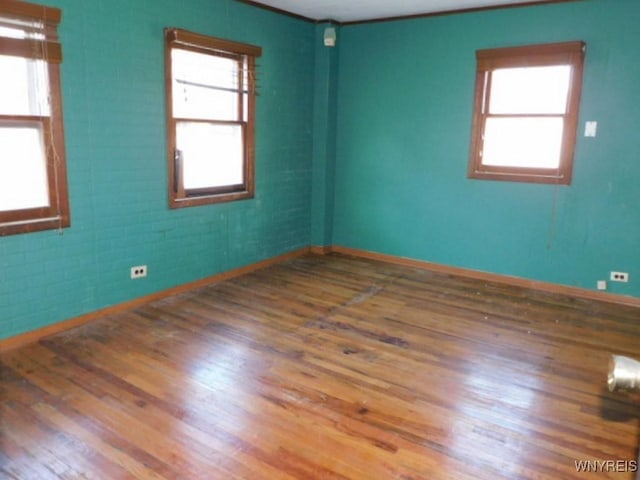 325 Ontario St, Lockport-City, NY 14094 - spare room featuring a healthy amount of sunlight, baseboards, and wood finished floors