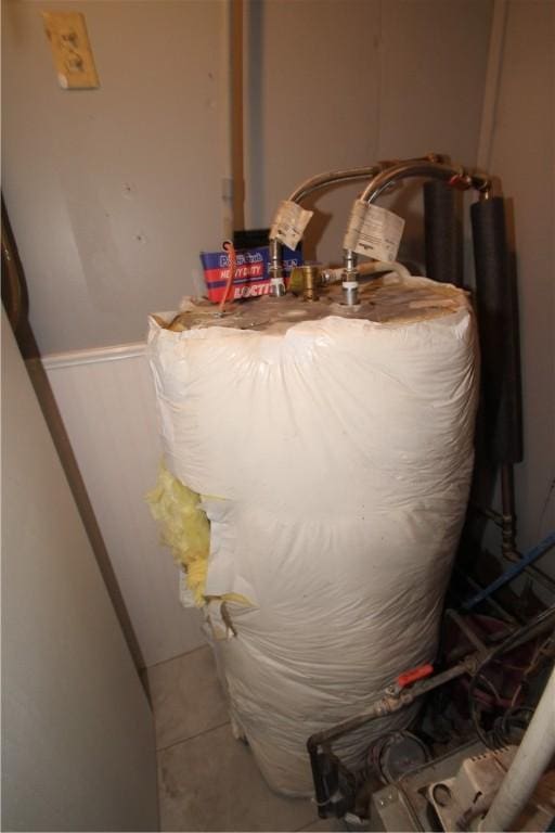 utility room featuring water heater